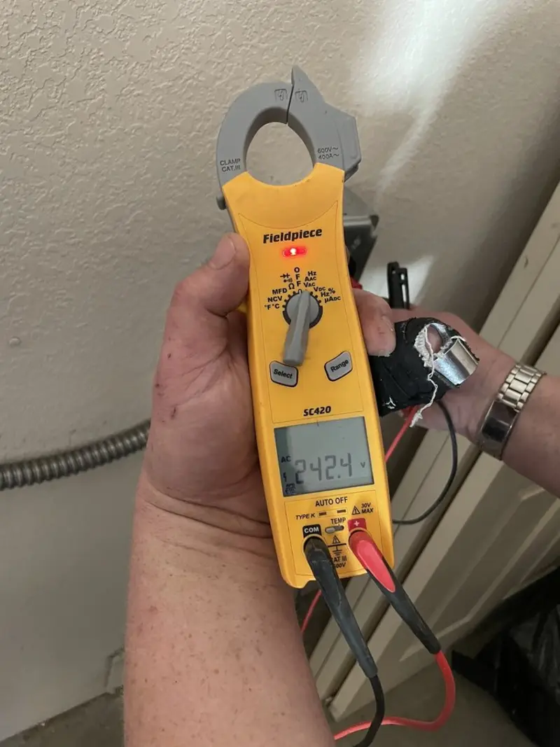 Voltage testing with clamp meter during Recessed Lighting Installation in Lowell